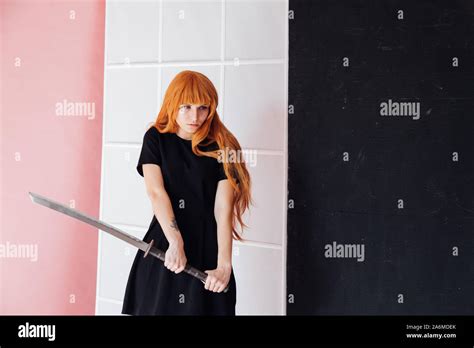 Girl sword Japan cosplayer anime red hair Stock Photo - Alamy