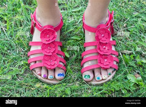 children`s feet in red sandals and painted toenails Stock Photo - Alamy