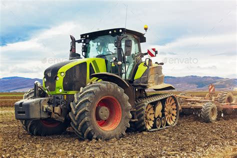 Modern tractor working on the farm, a modern agricultural transport ...