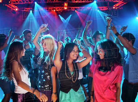 Smiling friends dancing on dance floor of nightclub - Stock Photo ...