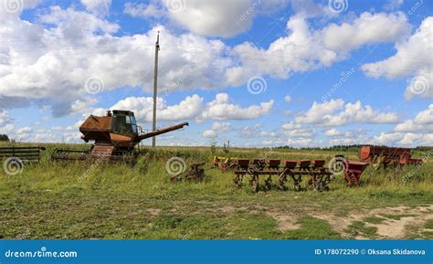 Silage and Forage Harvesting Equipment is Standing on the Edge of the Field, Waiting for Work. a ...