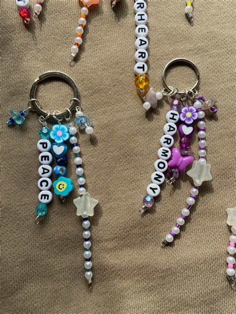 several key chains with charms attached to them on a cloth covered ...