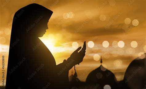 Silhouette of muslim woman praying with prayer beads Stock Photo | Adobe Stock