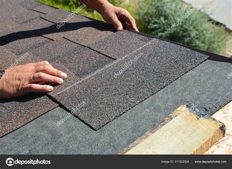 Asphalt Shingles Installation. Roofer Contractor Installing Asphalt Shingles on House Roofing ...