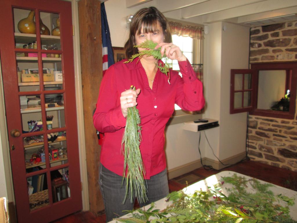 Debbie using greens to decorate The Moland House