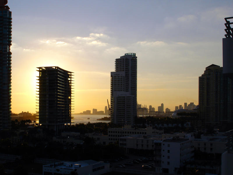 sunset through beachfront hotels of miami, florida