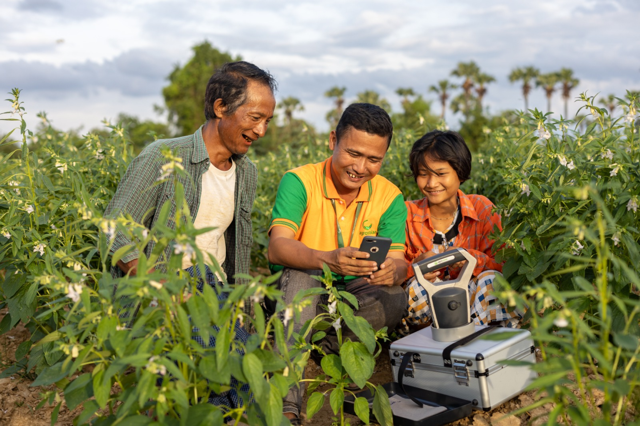 Farmers with Agros worker in the field