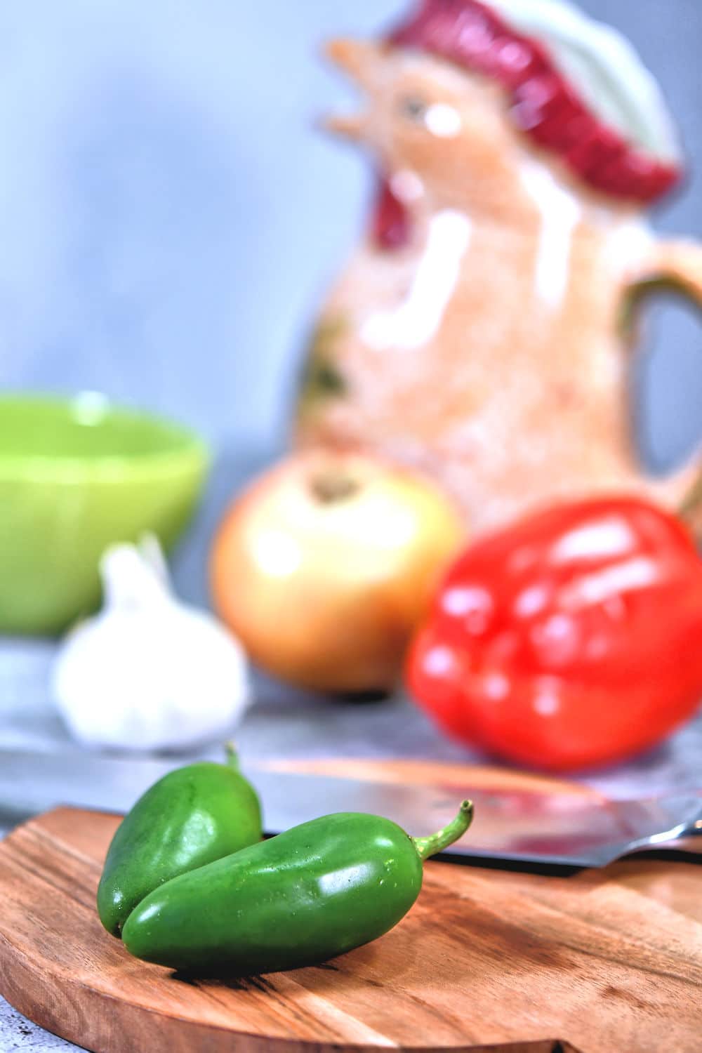 closeup of jalapeno peppers on a cutting board