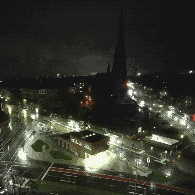 (a city view from a higher point at night)