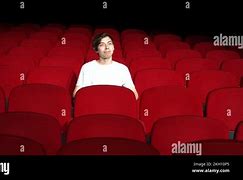 Image result for Man Sitting On Stage in Empty Theatre with Spotlight