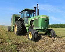 Image result for Tractor and Hay Baler