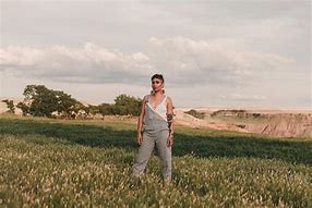 Image result for Woman Standing in Grassy Field with Flowers No Water Mark