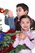 Image result for Child Decorating a Christmas Tree