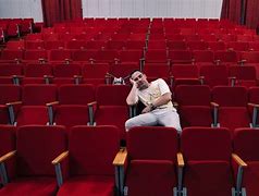 Image result for Man Sitting On Stage in Empty Theatre with Spotlight