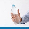 Person Holding Water Bottle On White Background