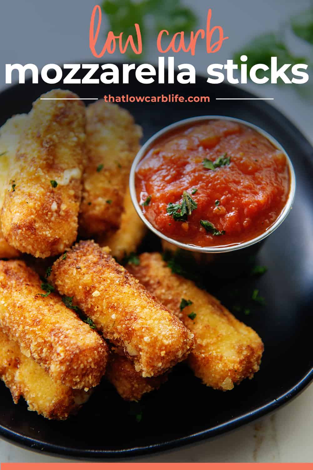 low carb mozzarella sticks on black plate with text for Pinterest.