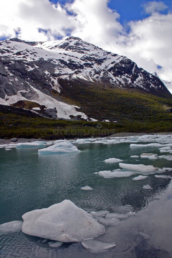 Mountain lake with ice floating in it stock photo