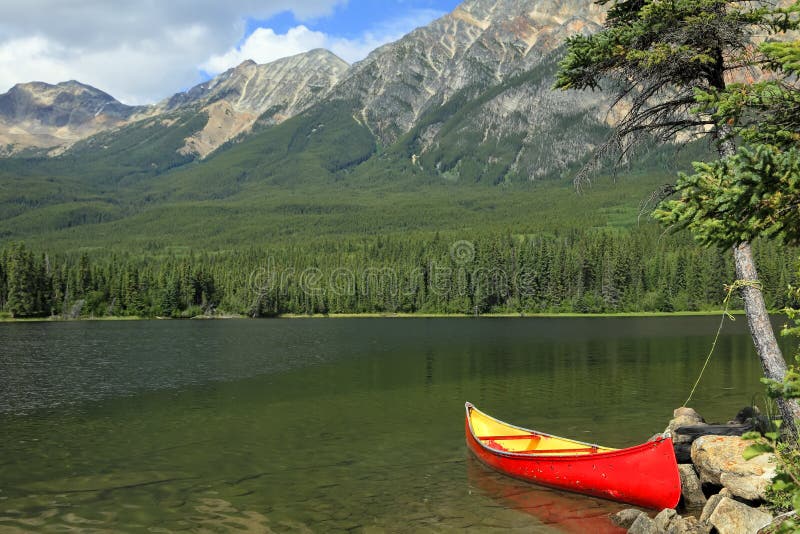 Red canoe moored on the bank