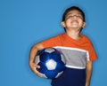 Boy holding soccer ball.