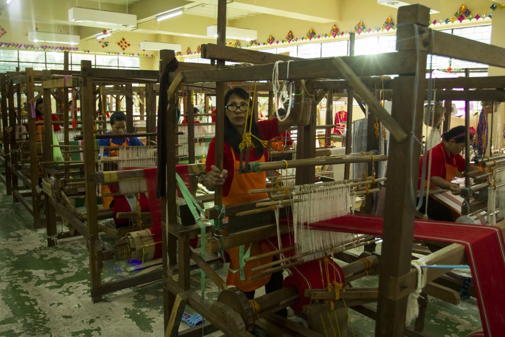 A woman weaving a traditional fabric