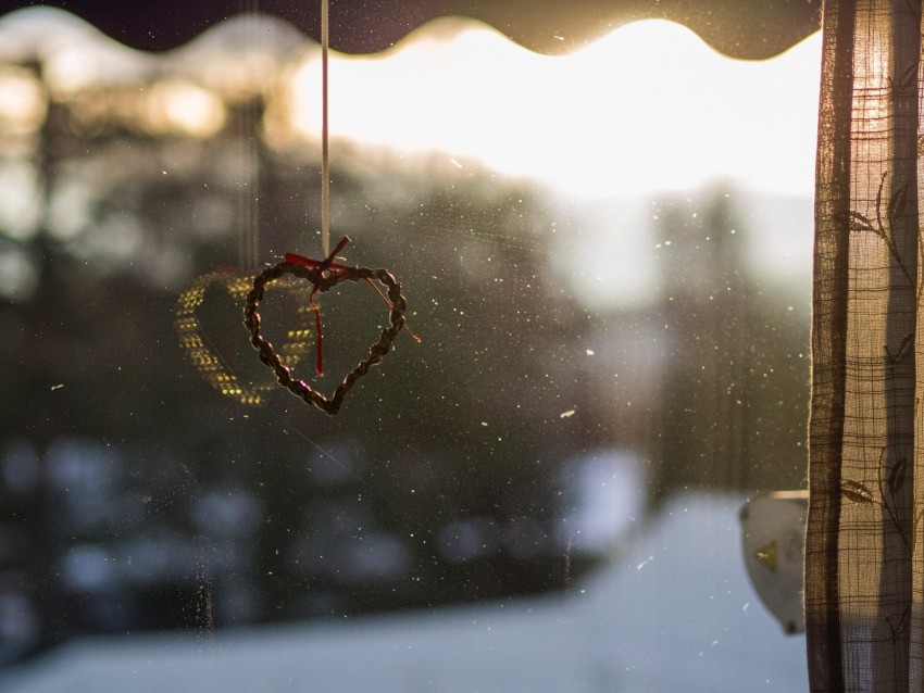 heart decoration, sunlight reflection, window view, romantic ambiance, home decor