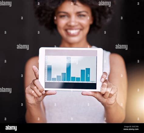 The numbers dont lie. Portrait of a smiling young business owner holding up a tablet displaying ...