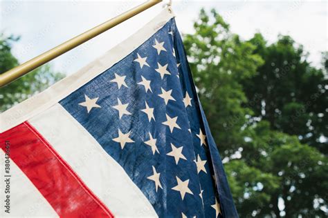 American flag hanging outdoors under a tree Stock Photo | Adobe Stock