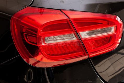 Close-up on the Rear LED Brake Light of Red Color on a Black Car in the Back of a Suv after ...