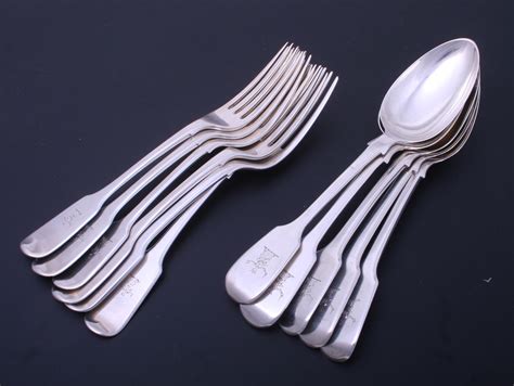 STEWART: A collection of matched antique silver fiddle pattern dessert spoons and forks ...