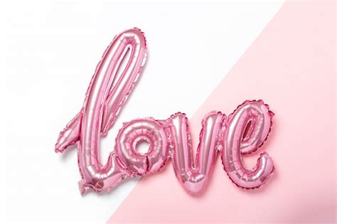 Premium Photo | Pink balloons in the form of word Love on pink and white color