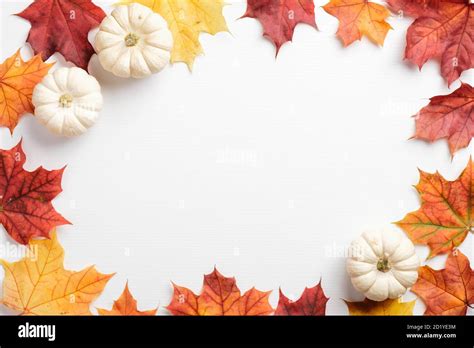 Autumn leaves and pumpkins border frame on white table. Seasonal background. Autumn fall ...