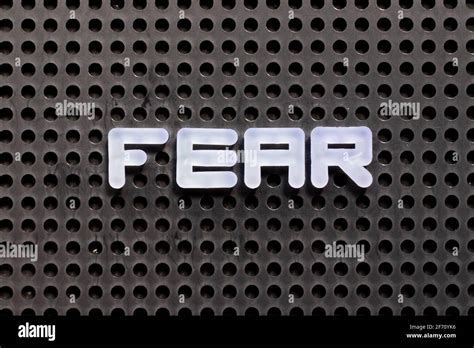 White color letter in word fear on black pegboard background Stock Photo - Alamy