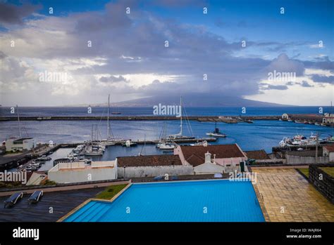 Portugal, Azores, Faial Island, Horta. Elevated view of waterfront and Pico Volcano Stock Photo ...