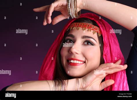 Beautiful oriental girl on dark colorful background Stock Photo - Alamy