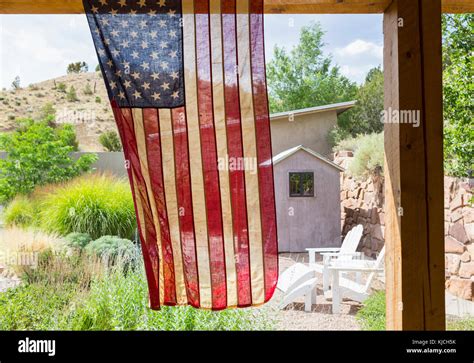 American flag hanging in backyard Stock Photo - Alamy