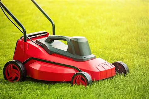 Premium Photo | Lawnmower on green grass Mowing the lawn