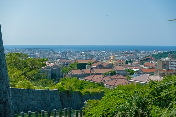 Okinawa Naha City Skyline Scenery from Shurijo castle park trail lookout, includes some buildings red roofs of Okinawa Prefectural University of Arts