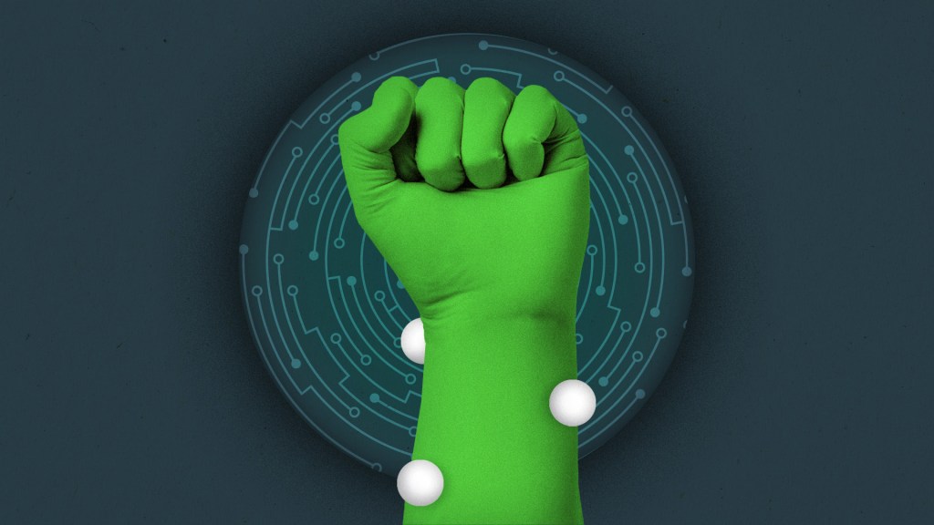 Fist in the air with a VFX green screen suit on