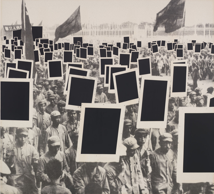 A large crowd of people holding blank black signs and flags, creating a striking visual contrast in a monochrome setting.