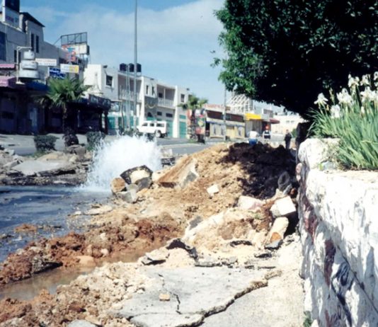 Water main in the Palestinian West Bank  burst by an Israeli army tank