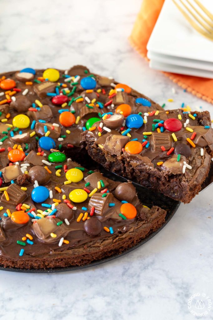 cutting a slice out of brownie pizza