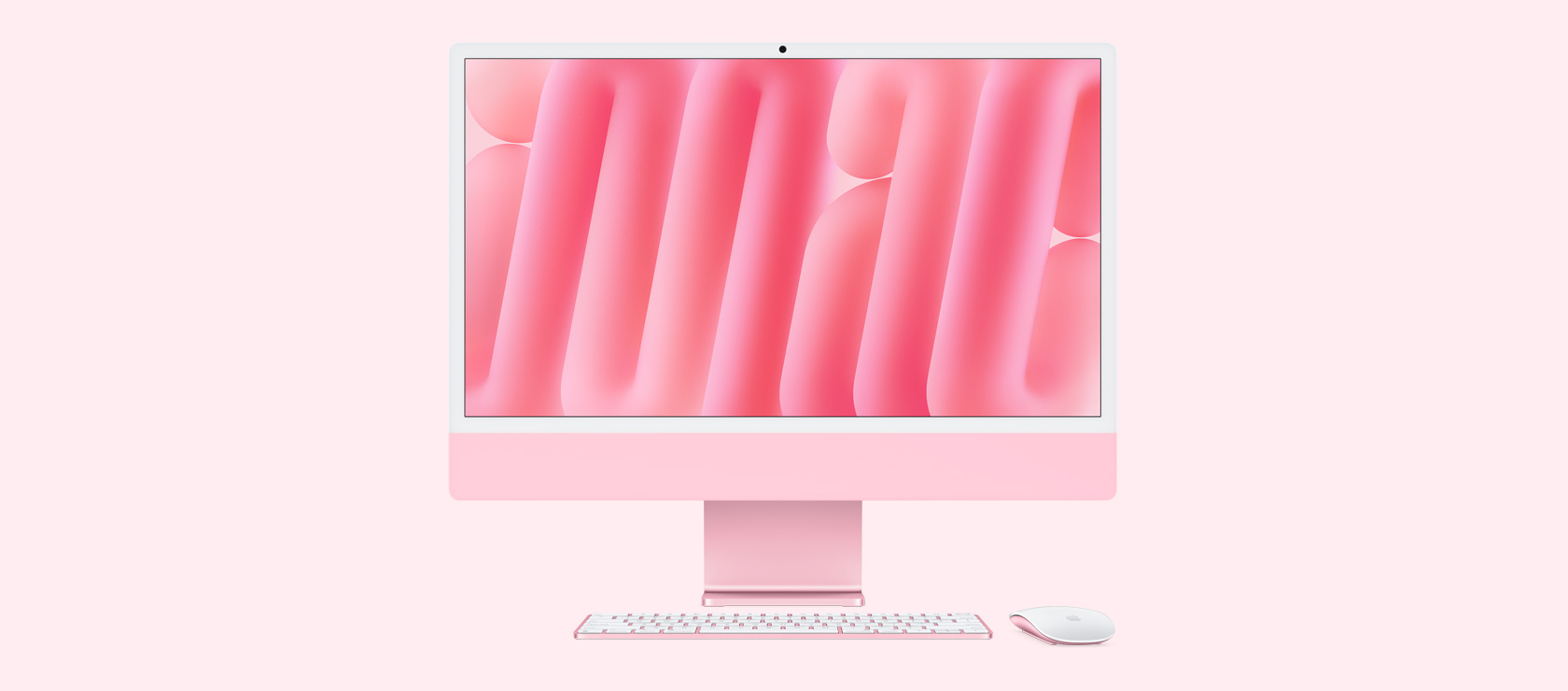 لقطة أمامية لجهاز iMac باللون الوردي مع ماوس ولوحة مفاتيح بلون يطابق لون الجهاز