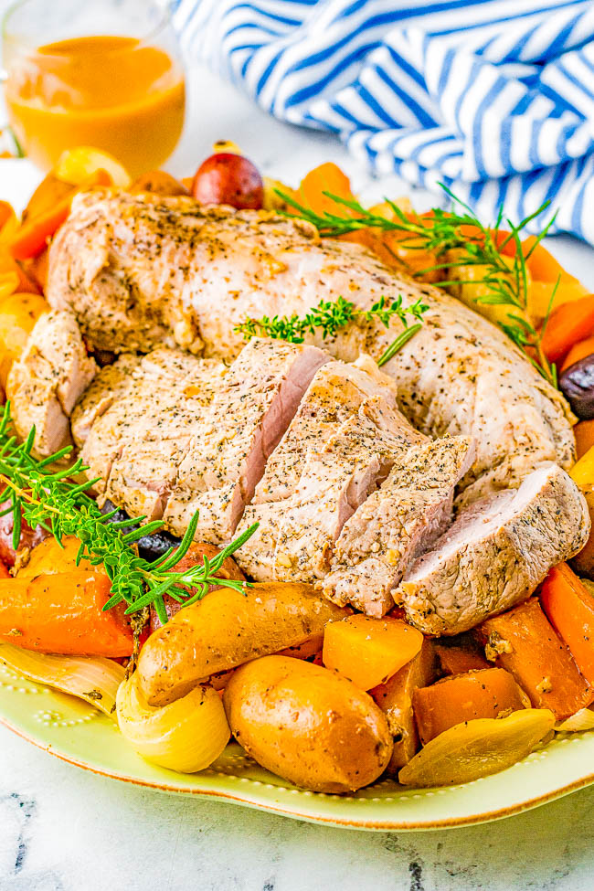 Slow Cooker Pork Loin - Tender, juicy pork loin is slow cooked with hearty vegetables for a complete and EASY meal! Reminiscent of a hearty and rustic recipe, yet fancy enough for a special dinner or holiday entertaining!