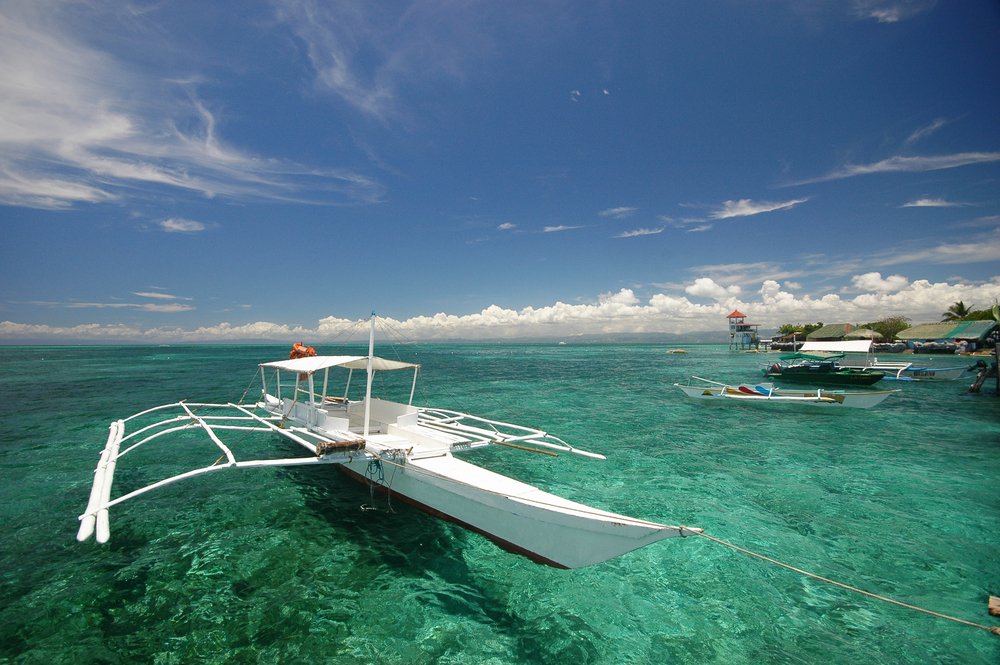 white boat on turquise water in Mactan Philippines