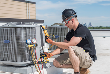 Male HVAC technician uses equipment to identify problems with HVAC unit.