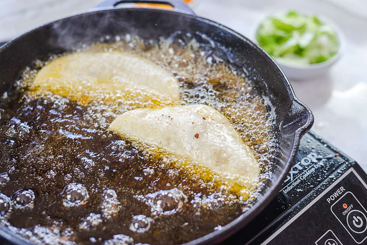 tacos frying in oil.