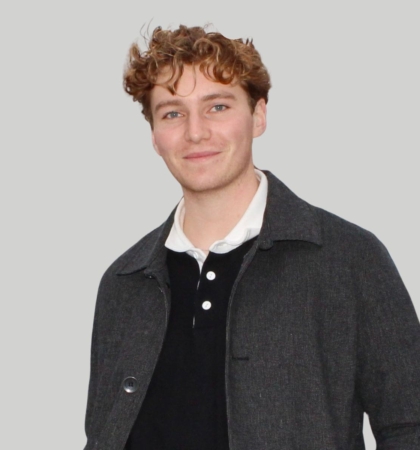 headshot of man on gray background