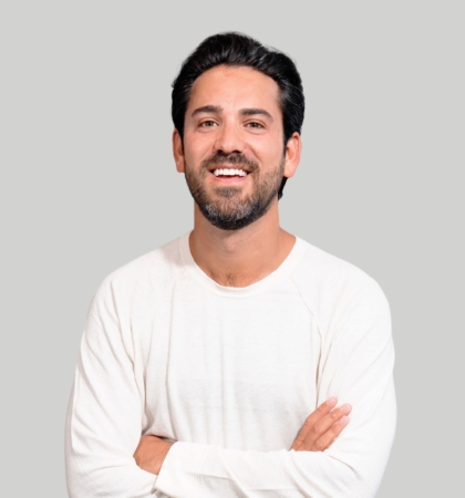 headshot of man on gray background