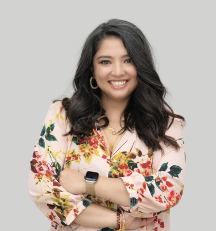 headshot of woman on grey background