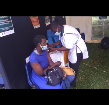 Ms Linet Khatambi, 35, receives her first COVID-19 vaccine during the vaccination drive by religious leaders held at Nairobi's Ufungamano House